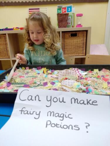 Mixing messy play fairy potions at Gower Day Nursery