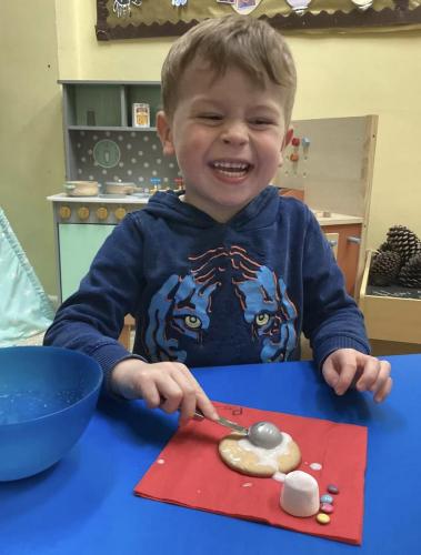 Enjoying making a melting snowman at Gower Day Nursery